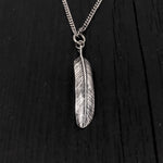 This raven feather is made of solid .925 sterling silver. It is double sided with natural curves that reveal it to be a wing feather. The bail was formed by curling the quill into a circle This lightweight feather measures 1-3/8" long.
