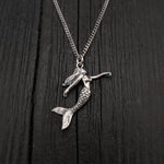 Pendant width: 1 Inches; Pendant height: 1 1/4 Inches. This three dimensional mermaid is cast of sterling silver, it is a solid sterling casting not hollow. Being expertly detailed on all sides, it can be worn with either side showing.