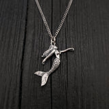 Pendant width: 1 Inches; Pendant height: 1 1/4 Inches. This three dimensional mermaid is cast of sterling silver, it is a solid sterling casting not hollow. Being expertly detailed on all sides, it can be worn with either side showing.
