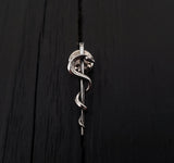 Silver snake coiled on black background, sleek texture | Moon Raven