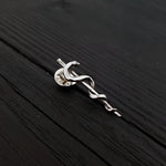 Silver snake pin on wooden table, intricate design | Moon Raven