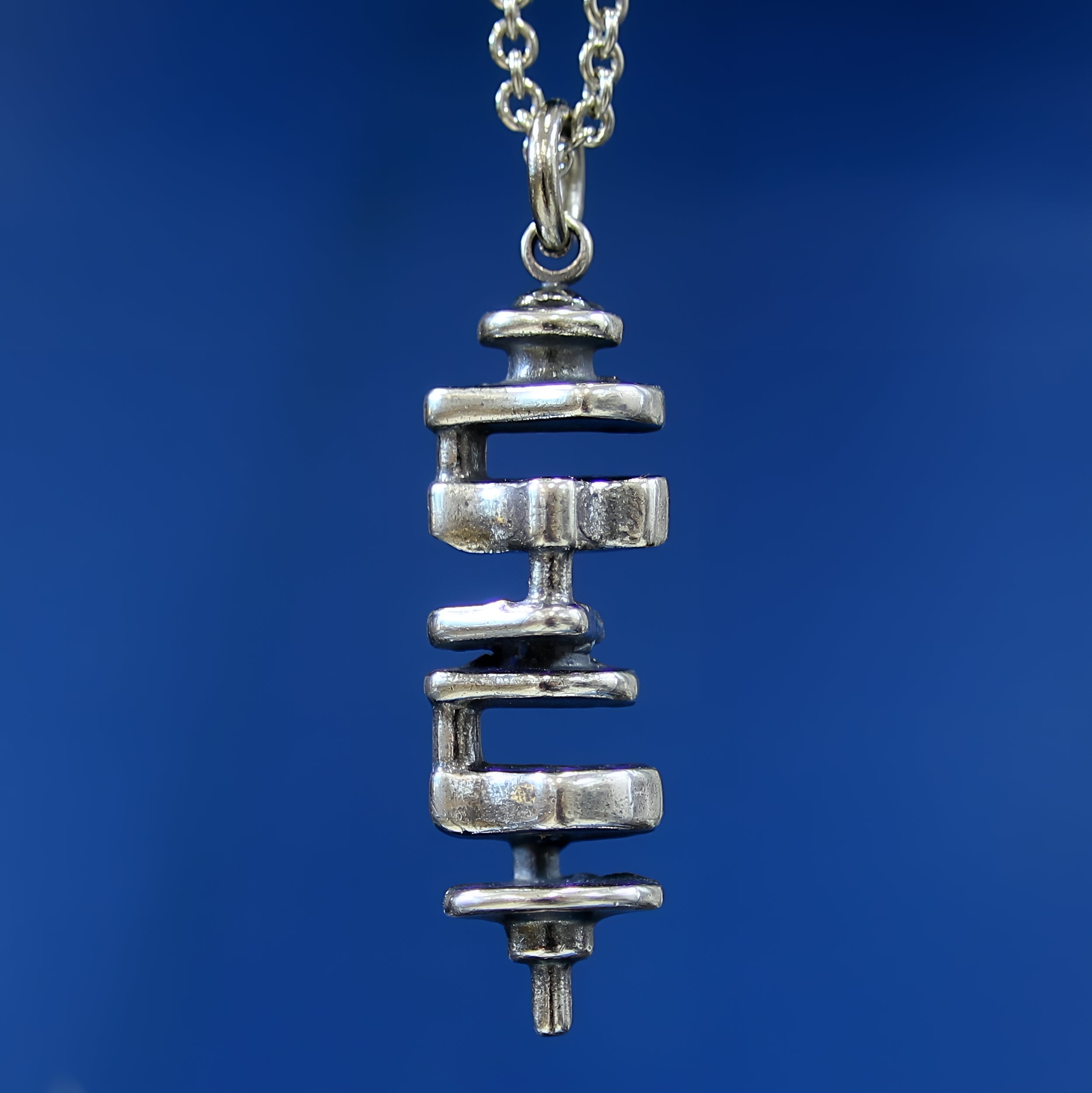 Silver necklace with fine chain on neutral backdrop