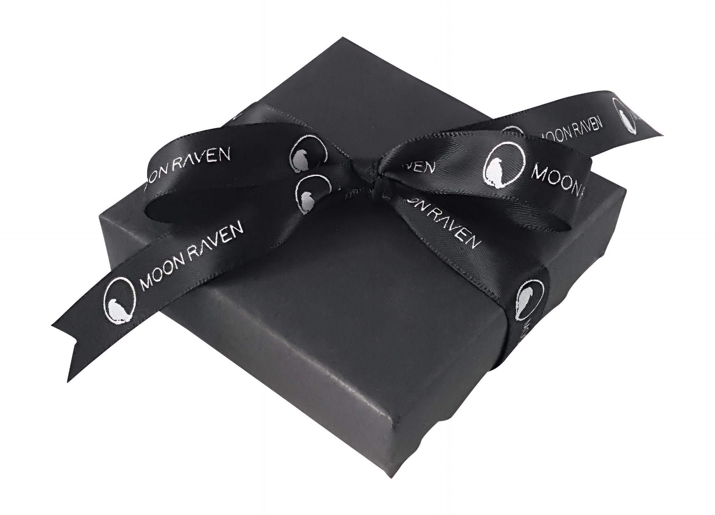 A black gift box with a black ribbon tied around it, featuring the text "Moon Raven" printed on it.