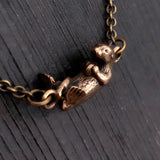 Floating Otter Necklace – Handcrafted Bronze Otter Pendant With Claw Clasp
